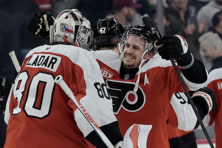 Flyers Travis Konecny hugs goalkeeper Dan Vladař following the Flyers' 2-1 overtime win against the Minnesota Wild at Xfinity Mobile Arena on Saturday.