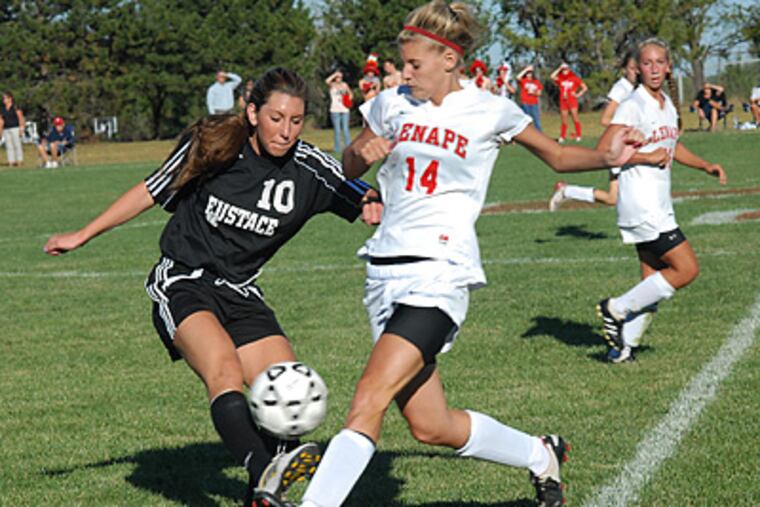Bishop Eustace's Brittney Stone, left, goes in for a tackle against Lenape's Dunfee McKenna. (April Saul / Staff Photographer)
