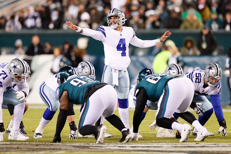 Dallas Cowboys quarterback Dak Prescott signals at the line during the game against the Eagles on Jan. 8 at Lincoln Financial Field.