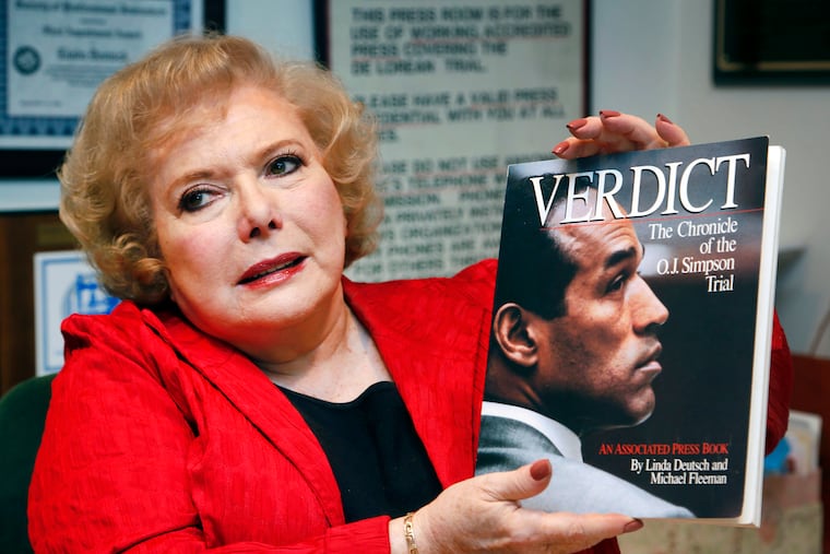 Associated Press special correspondent Linda Deutsch holds a copy of her book, "Verdict, The Chronicle of the O.J. Simpson Trial," in 2014. Deutsch has died at 80.