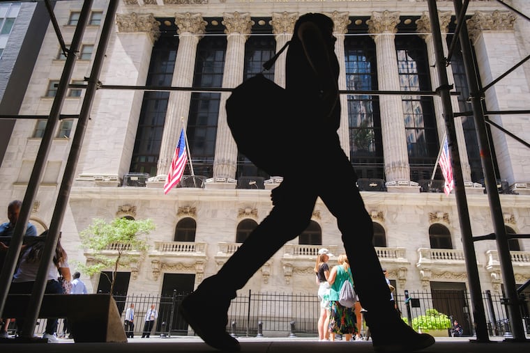 A pedestrian walks past the New York Stock Exchange in New York City on Thursday.