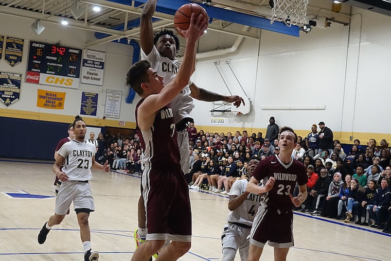 Wildwood's Tyler Tomlin, who had a game-high 23 points, goes hard to the basket in the first half against Clayton.