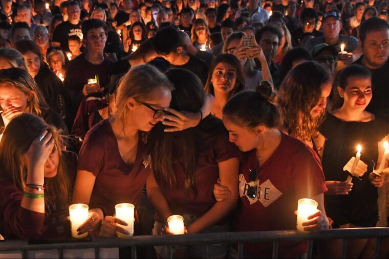 Mourners gather at a vigil that was held for the victims of the mass shooting at Marjory Stoneman Douglas High School in Parkland, Fla., on Thursday, Feb. 15, 2018.