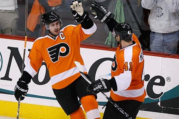 Mike Richards celebrates with Andrej Meszaros after scoring a goal in the third period. (Matt Slocum/AP)