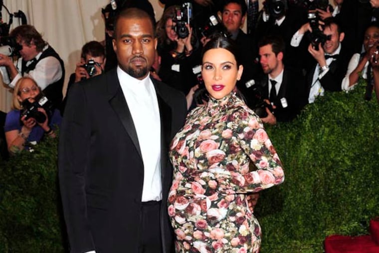 FILE - This May 6, 2013 file photo shows rapper Kanye West and Kim Kardashian attending The Metropolitan Museum of Art's Costume Institute benefit celebrating "PUNK: Chaos to Couture" in New York. A birth certificate released by the Los Angeles County Dept. of Public Health shows that the couple's daughter North west, was born on Saturday, June 15, 2013 at Cedars-Sinai Medical Center in Los Angeles. (Photo by Charles Sykes/Invision/AP, file)
