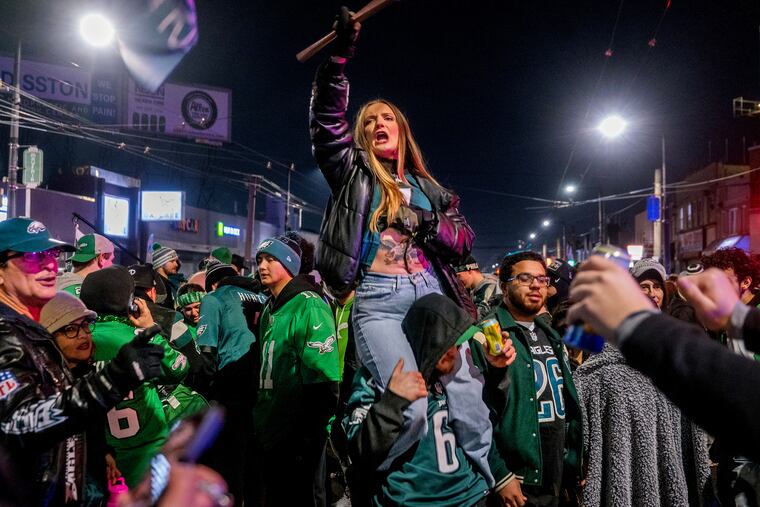 Birds fans gather at Frankford & Cottman in Mayfair Sunday, celebrating after the Eagles won the NFC championship game against the Washington Commanders.