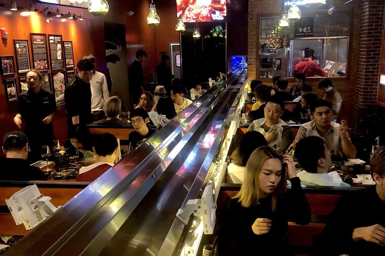 The rail carries a small train bearing hot food from the kitchen at Chubby Cattle.