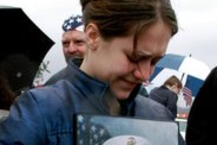 Four years ago in a steady rain, Jen Dunckley held a portrait of her husband, Allen James Dunckley Jr., at a support rally in Feasterville, Bucks County, during his first tour of duty in Iraq.