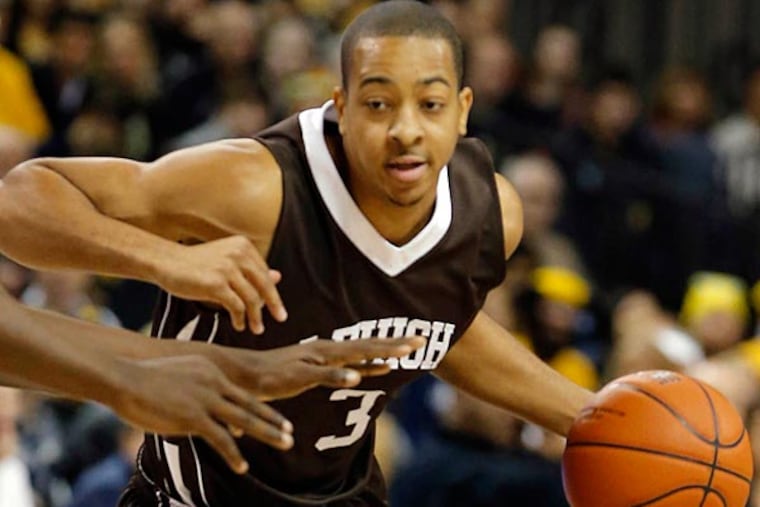 Lehigh's C.J.McCollum tries to get around a VCU defender during first
half of an NCAA college basketball game in Richmond, Va., Sat. Jan 5,
2013. (AP Photo/The Richmond Times-Dispatch, Joe Mahoney)