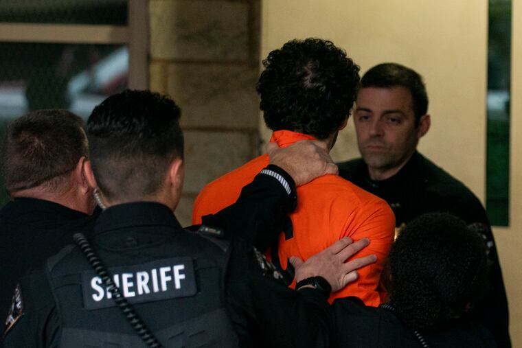 Suspect Luigi Mangione is taken into the Blair County Courthouse on Tuesday in Hollidaysburg, Pa.