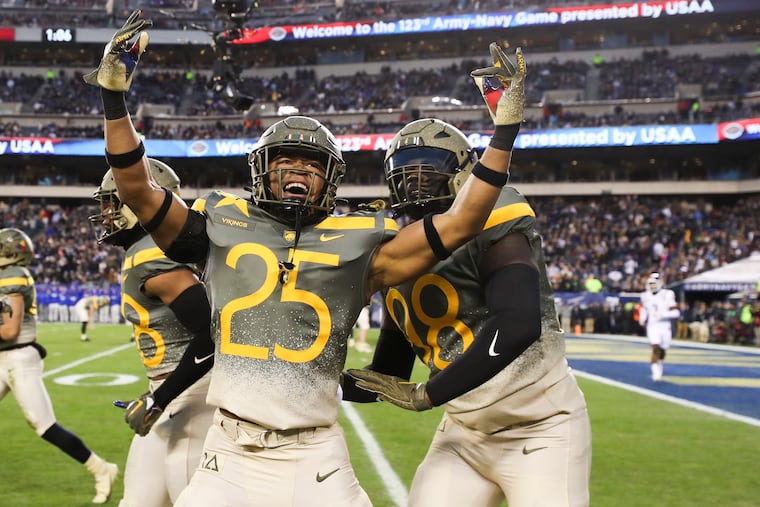 Army players, including Josiah Banks (25), celebrate after a blocked punt is returned for a touchdown Saturday against Navy.