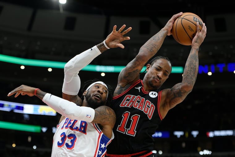 Bulls' DeMar DeRozan battles Sixers' Robert Covington for a rebound during the first half on Dec. 30.