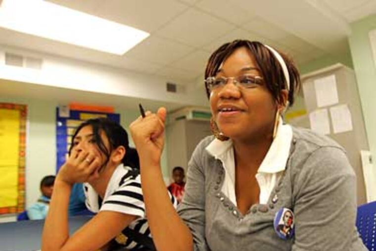 Saffronia Robinson (right) and Amanda Martinez, both 9th graders at Constitution High School, talk about Tuesday's historic election. (David Swanson / Staff Photographer)