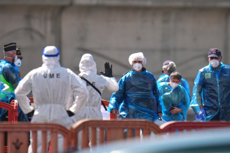 Passengers are disembarked from the hantavirus-stricken cruise ship MV Hondius at the port of Granadilla in Tenerife, Canary Islands, Spain, Sunday, May 10, 2026.