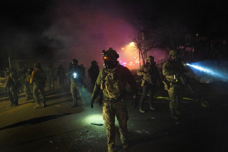 Federal agents, including members of Immigration and Customs Enforcement, are seen in Minneapolis in January amid the Trump administration’s push to visibly expand its immigration-enforcement efforts in American cities.