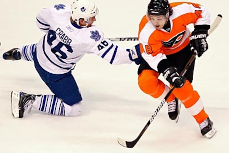 Danny Briere takes the puck from the Maple Leafs' Joey Crabb during the first period. (Steven M. Falk/Staff Photographer)