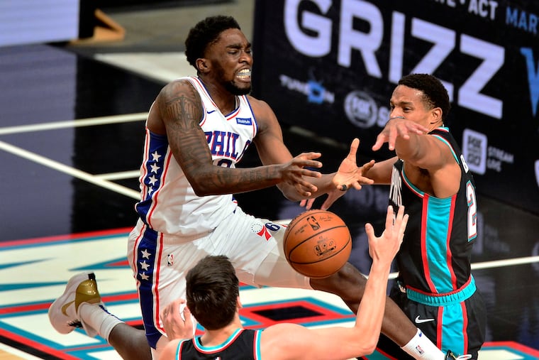 Philadelphia 76ers guard Shake Milton, left, loses control of the ball against Memphis Grizzlies guard Desmond Bane, right, in the second half of an NBA basketball game Saturday, Jan. 16, 2021, in Memphis, Tenn.