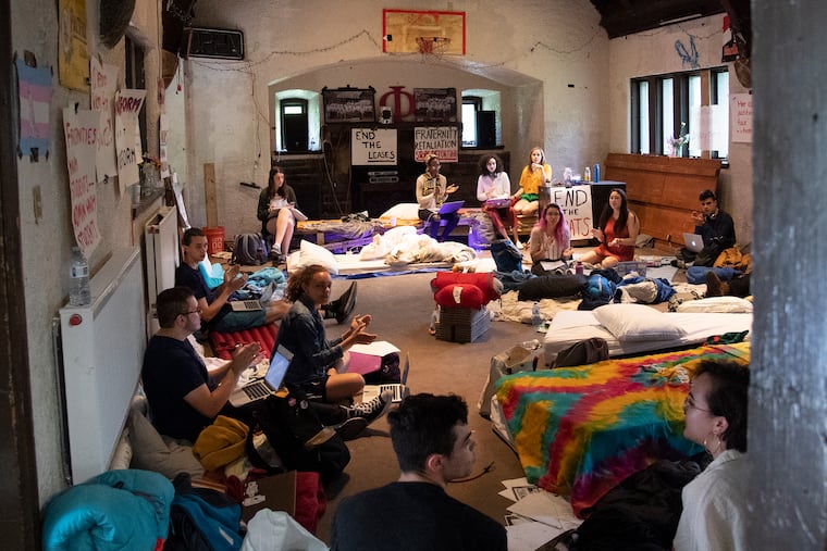 Students sing songs inside the main hall of the Phi Psi fraternity at Swarthmore College on Tuesday. The sit-in was organized by activists who wanted the school to permanently ban two fraternity organizations from operating on campus.