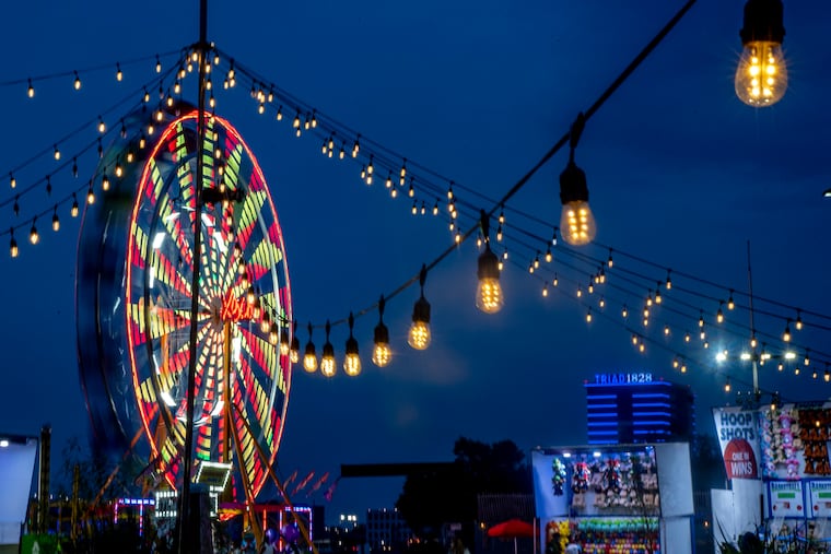 A slow camera shutter speed blurs the mooning Ferris Wheel on Penn's Landing in July 2020 at the Blue Cross RiverRink Summerfest.