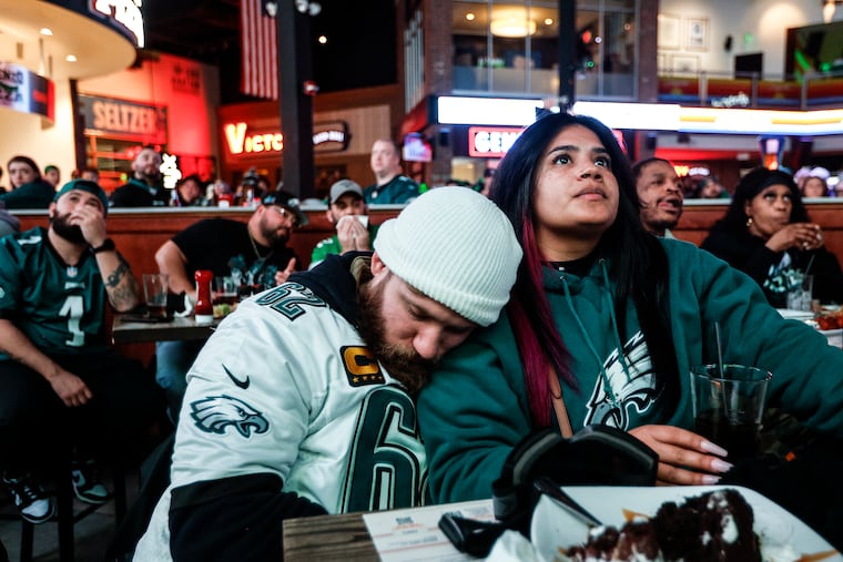 Eagles fans Thomas Sprenger, sleeping and Cecilia Andiron both from south Jersey at Xfinity Live watching the Eagles Tampa Bay wild card playoff game during the second quarter, Monday, January 15, 2024.