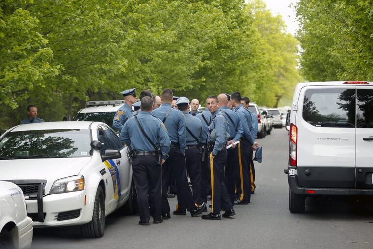 Officers gather along the road inside the Trump National Golf Club in Bedminster, N.J.