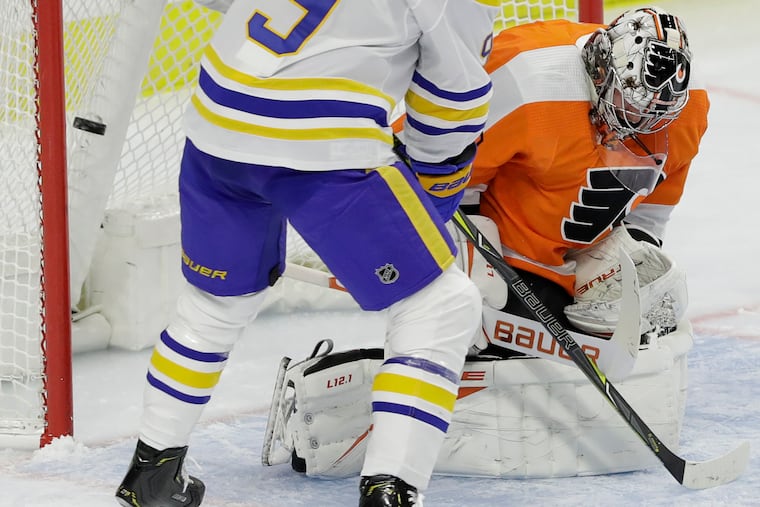 It's been a shooting gallery in front of the Flyers' goalies in the season's first five games. In this photo, Buffalo center Jack Eichel watches Sam Reinhart's shot get past Flyers goaltender Carter Hart on Monday.