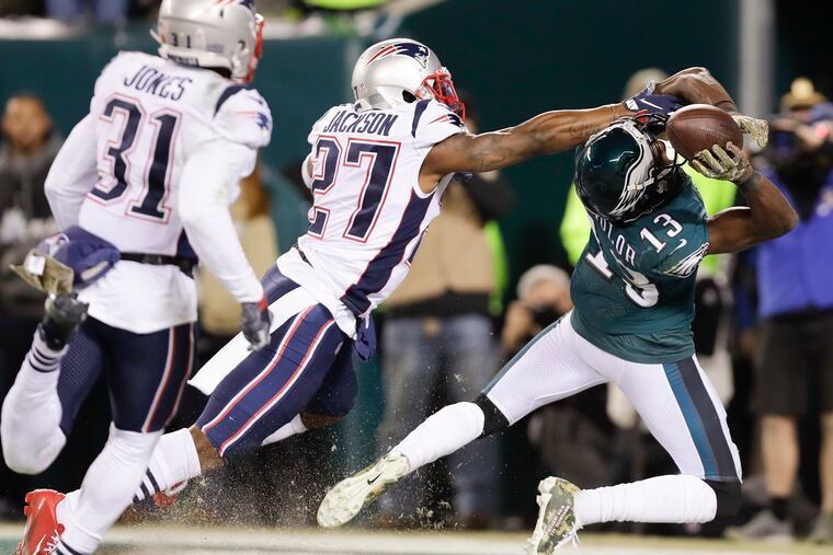 Eagles wide receiver Nelson Agholor fails to catch the ball in the end zone late in the fourth quarter ahead of Patriots J.C. Jackson and Jonathan Jones.
