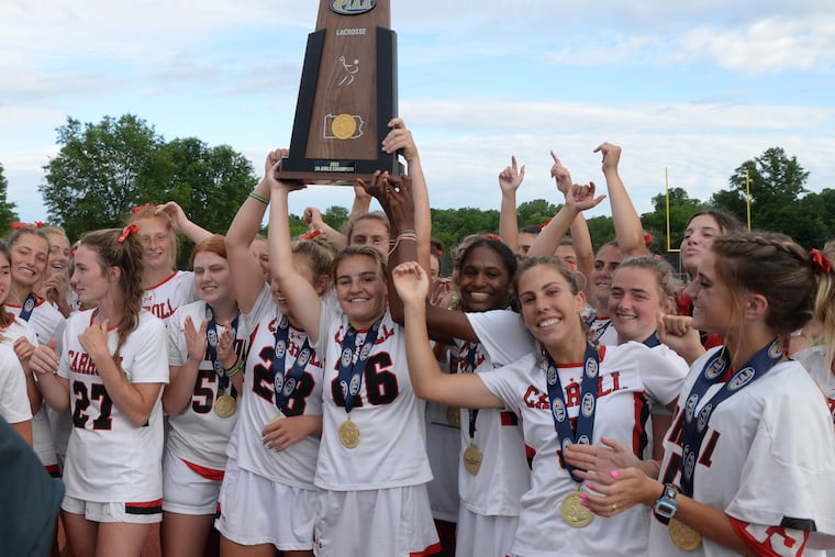 Katy Koroly of Archbishop Carroll holds up the championship trophy after the victory against Twin Valley in the PIAA Class 2A final.