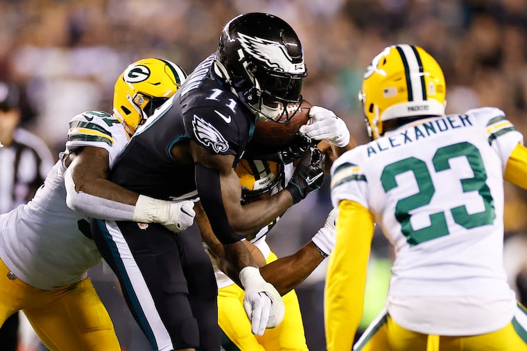 Eagles wide receiver A.J. Brown fumbles the football against Green Bay Packers linebacker Krys Barnes (left) with cornerback Jaire Alexander during the second quarter on Sunday, November 27, 2022 in Philadelphia.