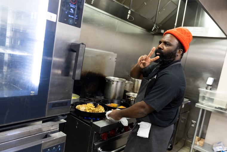 Chef Omar Tate cooking for a dinner called “UNTITLED" at Honeysuckle Provisions in West Philadelphia in January 2024.