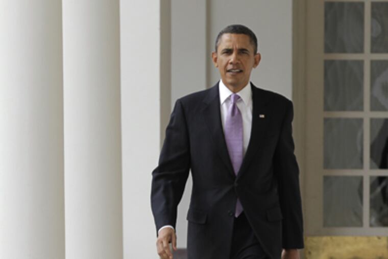 President Obama strides from the Oval Office along the Colonnade today at the White House in Washington. (J. Scott Applewhite / AP Photo)