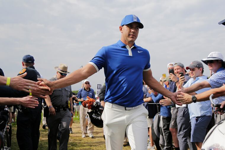 Brooks Koepka greets spectators as he walks to the 12th tee during the second round of the PGA Championship golf tournament, Friday, May 17, 2019, at Bethpage Black in Farmingdale, N.Y. (AP Photo/Seth Wenig)