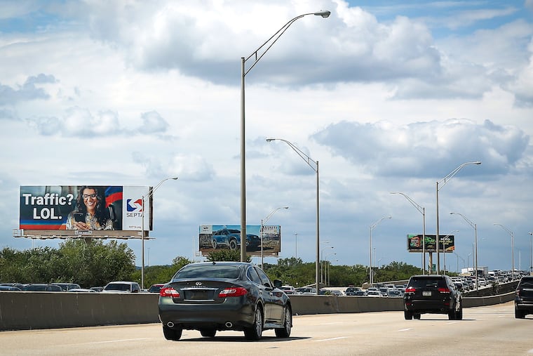 A billboard above I-95 near Philadelphia International Airport states “Traffic? LOL.” as traffic backs up northbound due to a crash in 2025. From April 21 to May 17, the I-95 South exit ramp to Packer Avenue will be closed for construction.