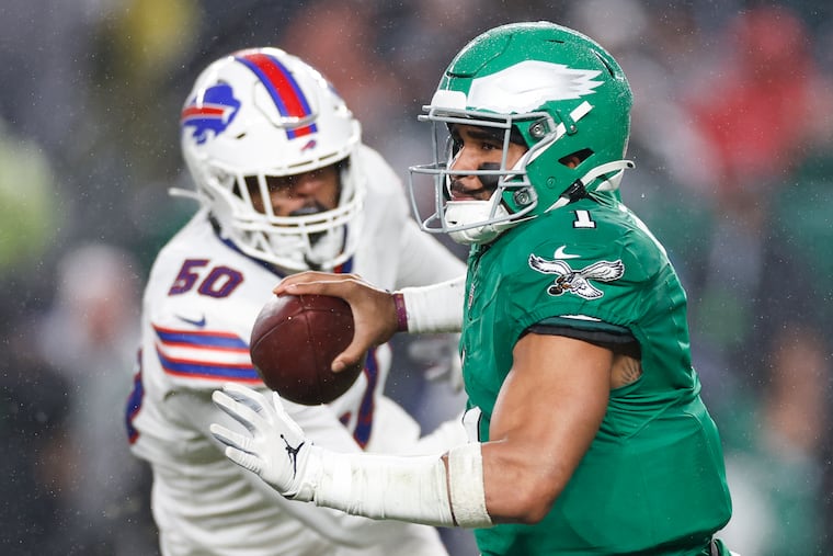 Eagles quarterback Jalen Hurts looks downfield as Bills defensive end Greg Rousseau moves in during their game on Nov. 26, 2023.