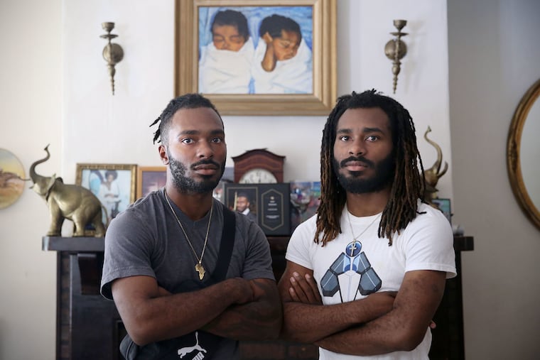 Twins Julian, left, and Julius Whitehead, who were both shot in 2018, stand for a portrait at their home in Philadelphia's Harrowgate section.