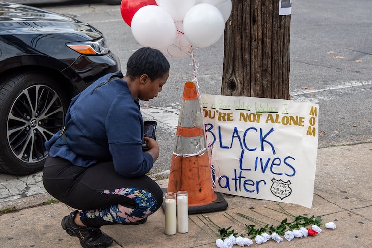 Neighbors gather near a memorial outside Walter Wallace Jr.'s home in West Philadelphia Philadelphia, Pa. Tuesday, October 27, 2020. Police officers fatally shot Wallace, a 27-year-old Black man armed with a knife during a confrontation Monday afternoon in West Philadelphia, an incident that quickly raised tensions in the neighborhood and sparked a standoff that lasted deep into the night.