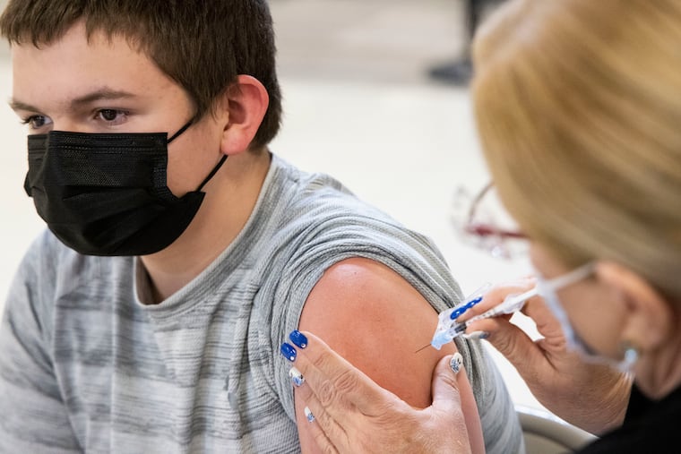 Braden Hardel, 14, of King of Prussia, gets vaccinated at the King of Prussia Mall in May.