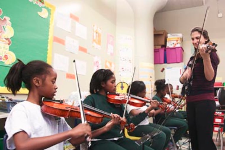 Amanda Wolman teaches Viola to student at Tune Up Philly : an after school music program sponsored by The Philadelphia Youth Orchestra. (Ryan S. Greenberg / Staff Photographer)