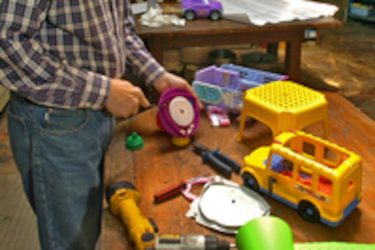Leo Sewell disassembles toys for use in creating Liberty's arm and torch at the new Please Touch Museum.