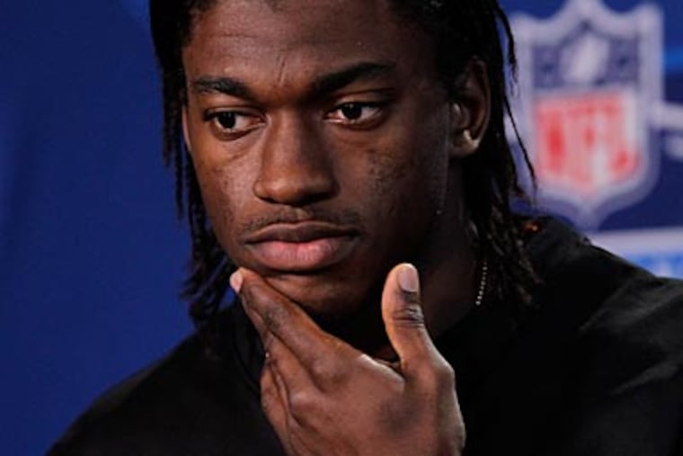 Quarterback Robert Griffin III, who won the Heisman Trophy, can run and throw equally well. (Michael Conroy/AP)