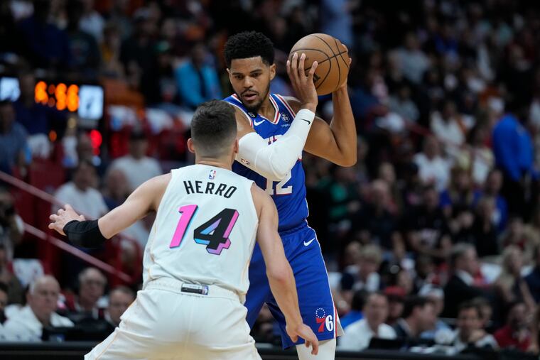 Philadelphia 76ers forward Tobias Harris (12) looks for an opening past Miami Heat guard Tyler Herro (14).