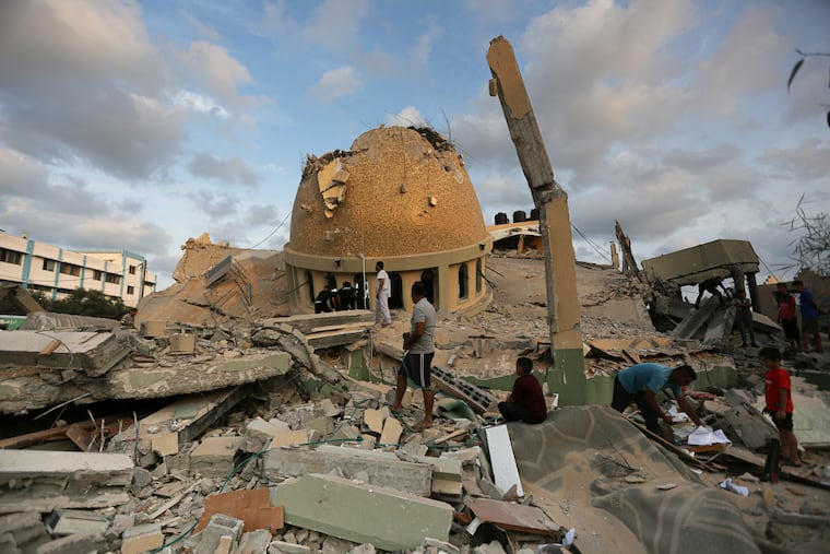 Residents of the Gaza Strip survey the damage at a mosque destroyed in an Israeli air strike in the town of Khan Younis on Sunday.