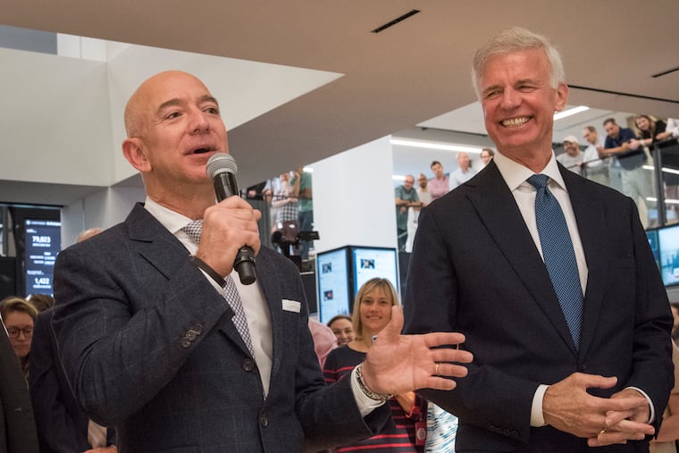 Jeff Bezos, left, makes remarks before a ribbon-cutting ceremony at The Washington Post in September 2018. At right is the Post's publisher, Fred Ryan.