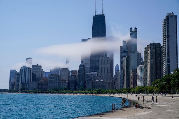 The Chicago city skyline is covered by the fog lifted off Lake Michigan on Aug. 5, 2022, in Chicago. Democrats have chosen Chicago to host their 2024 national convention.