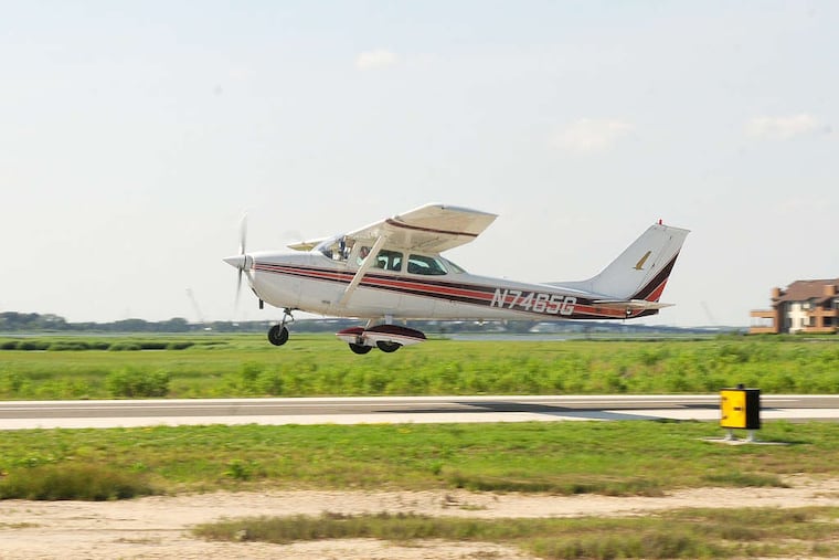 In this file photo, an airplane takes off from Ocean City Municipal Airport. Two people escaped injury Sunday morning when their plane overshot the runway and landed nose-first in a marsh.