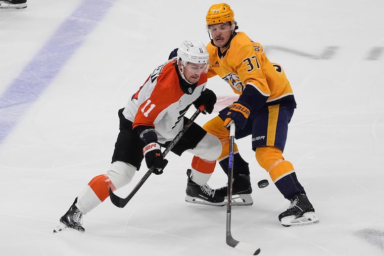 Flyers right wing Travis Konecny battles for the puck with Nashville defenseman Nick Blankenburg on Thursday.