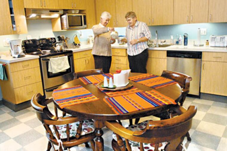 Sister Ann Provost, left; and Sister Margery Lowry in the kitchen of their convent, Mercy Neighborhood Ministries. (April Saul/Staff Photographer)