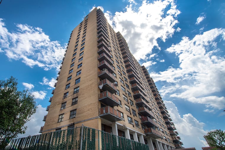 The 21-story Northgate 1 apartment tower in Camden, N.J., looms over the Benjamin Franklin Bridge Plaza. Tenants have coped with difficult conditions for years.