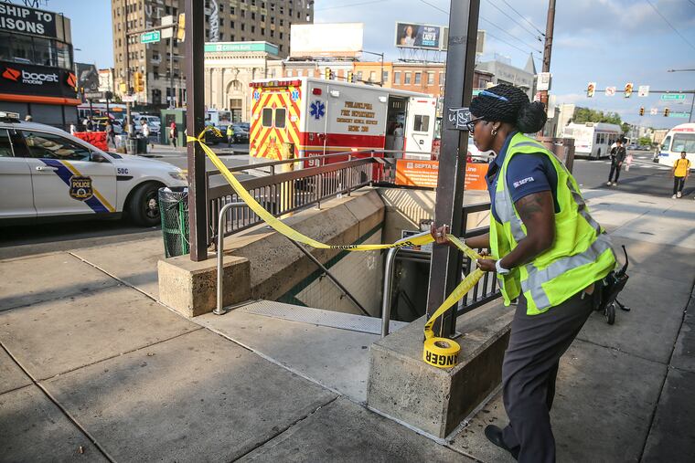 A SEPTA employee closes a subway entrance on the southwest corner of Broad and Erie streets following a fatal train accident, Monday, July 8, 2018. The victim was a SEPTA employee. STEVEN M. FALK / Staff Photographer