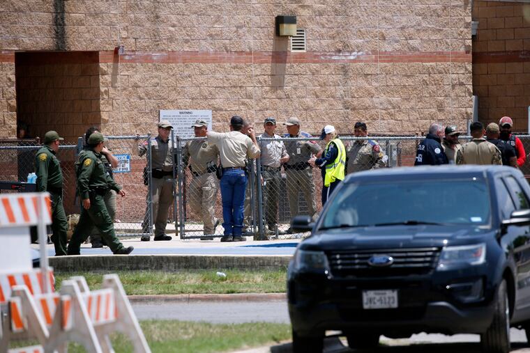 Law enforcement, and other first responders, gather outside Robb Elementary School following a shooting, on May 24, 2022, in Uvalde, Texas.